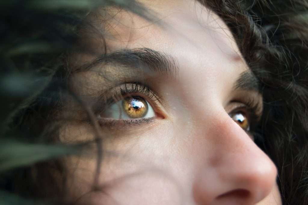 young woman showing prominent brown eyes