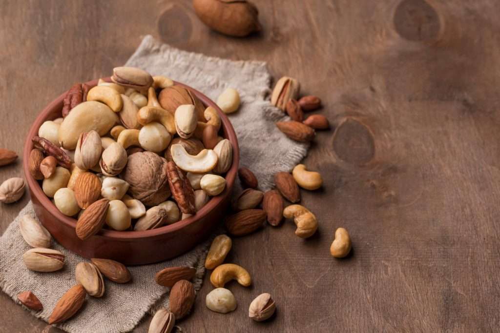 bowl-with-nuts-copy-space-wooden-background