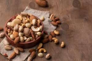 bowl-with-nuts-copy-space-wooden-background